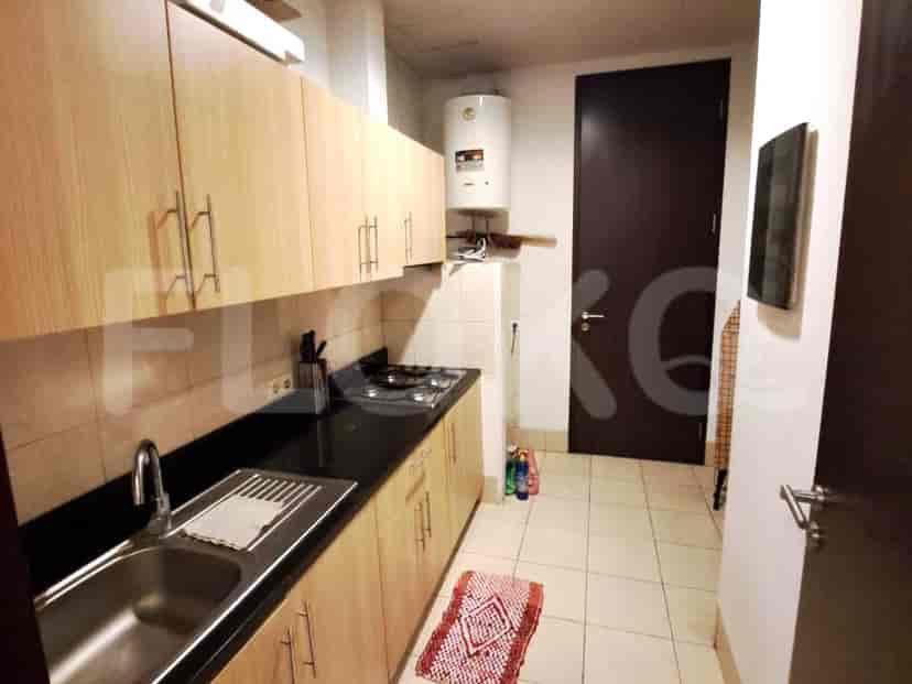 A functional kitchen with wooden cabinets and necessary appliances.