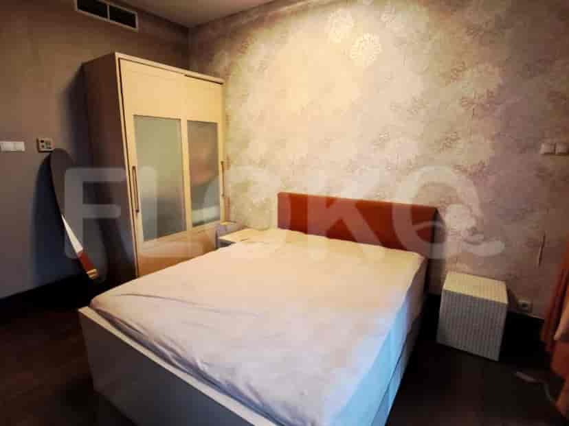 A bedroom with a double bed, wardrobe, and neutral color scheme.