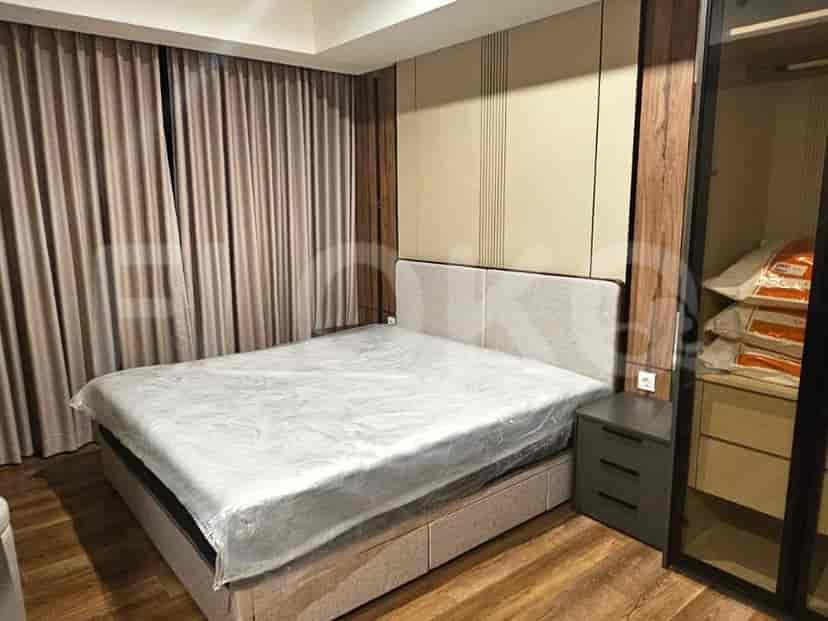 Bedroom featuring a large bed, nightstand, and curtains.
