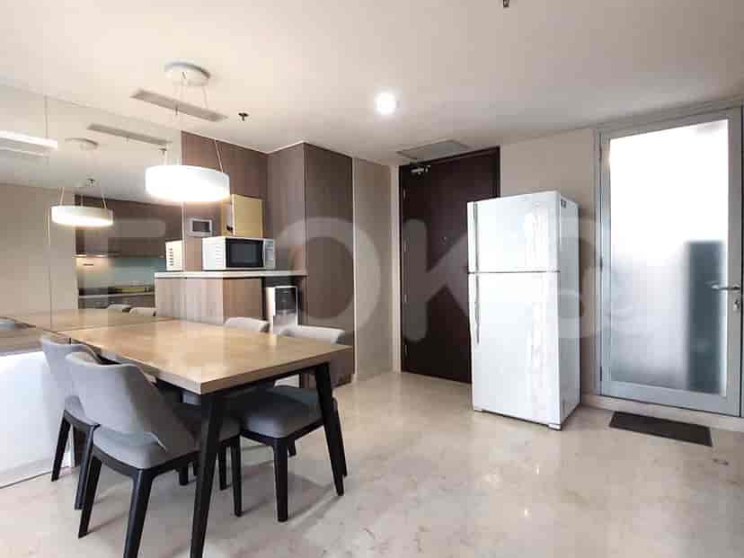 A combined dining and kitchen area with a dining table, chairs, and modern appliances.