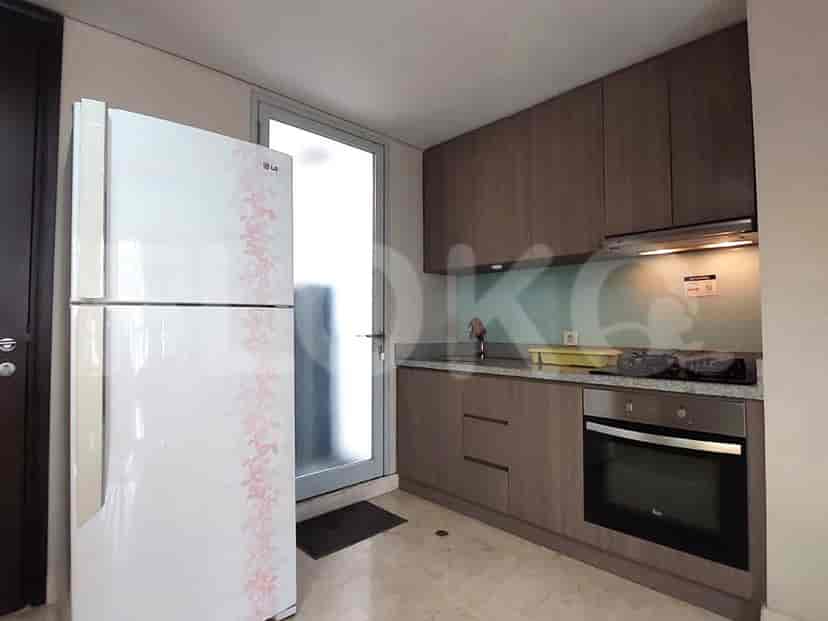 A well-equipped kitchen with wooden cabinets, a stove, and a refrigerator.