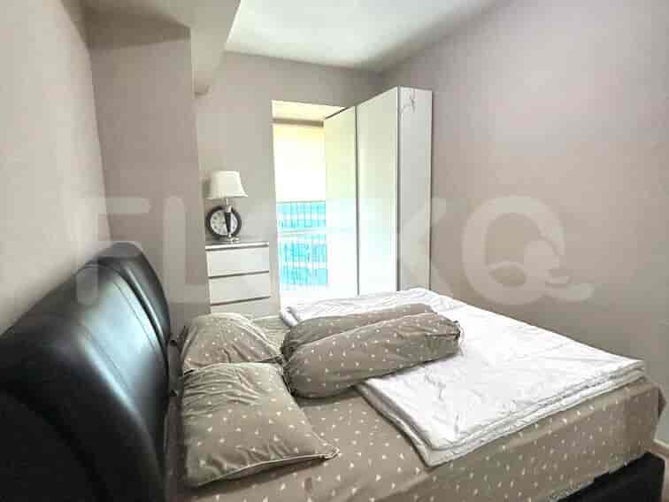 Bedroom with a bed, wardrobe, and side table.