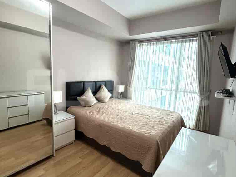 Bedroom with a double bed, bedside tables, and large mirror.