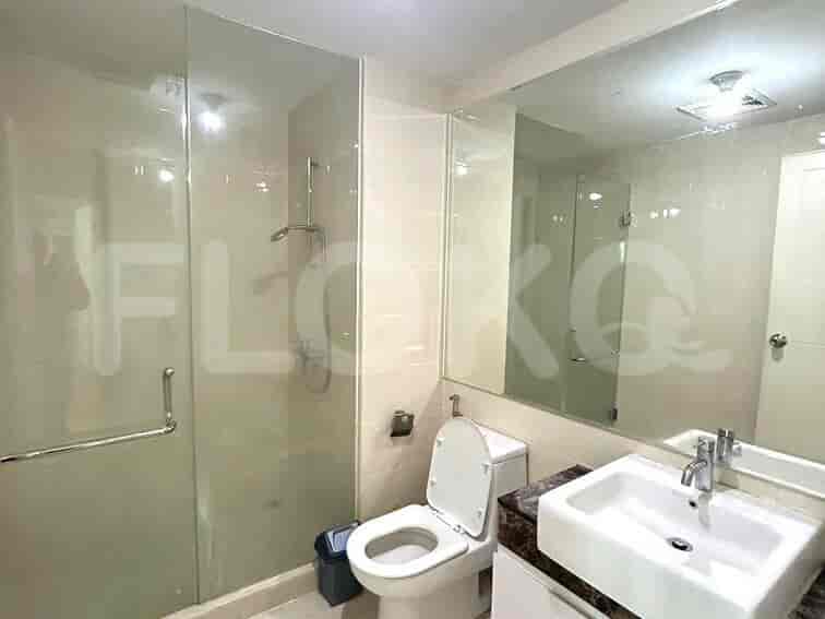 Bathroom with a shower, toilet, and sink with mirror.