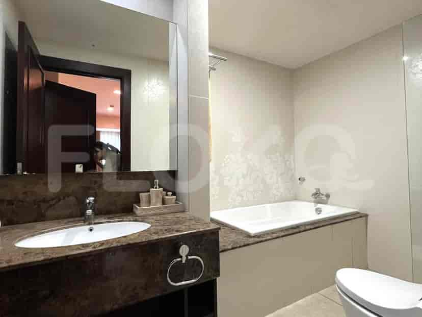 A luxurious bathroom with a bathtub, a vanity, and a large mirror.