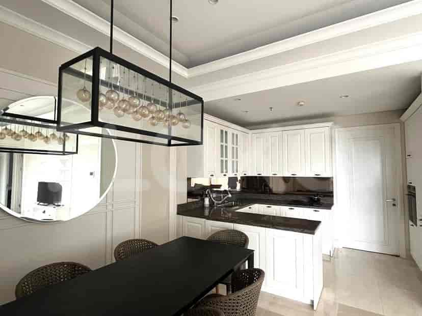 Kitchen with a dining area, featuring modern design and white cabinets.