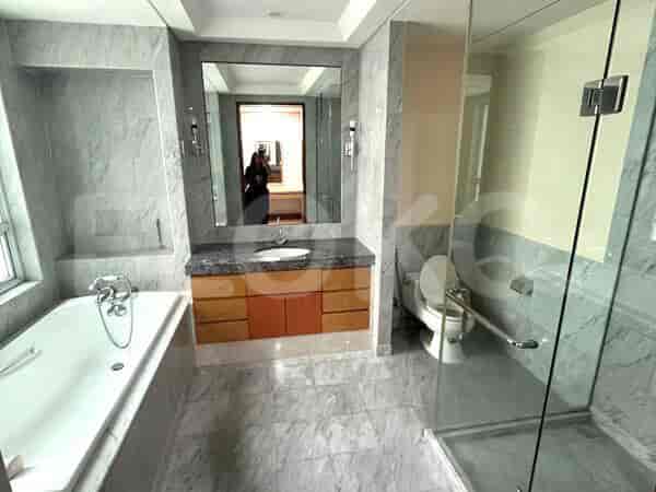 A luxury bathroom featuring a bathtub, a walk-in shower, and a vanity with a large mirror.