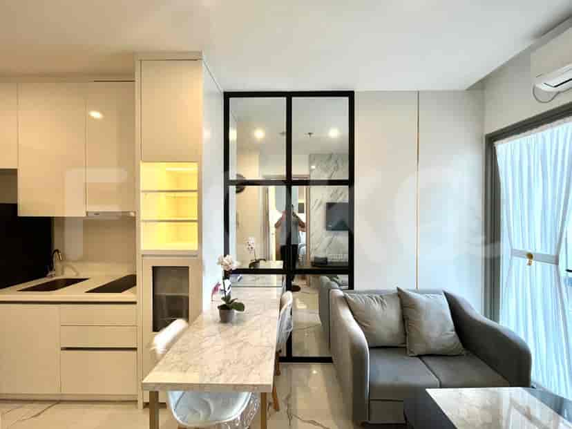 Modern kitchen with white cabinets, marble dining table, and view of the living area.