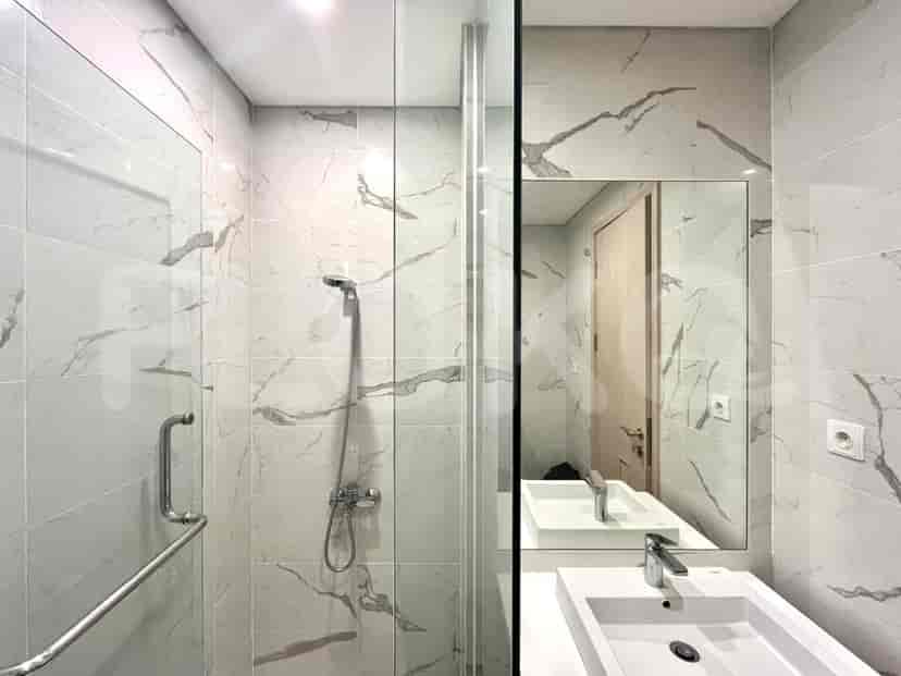 Modern bathroom with a marble tile shower, a vanity, and a mirror.