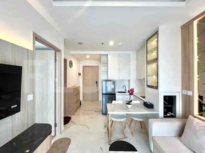 Another view of the kitchen and living area showcasing the layout and design.
