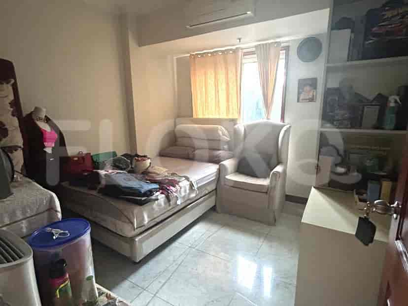 Bedroom with a bed, chair, and various items.