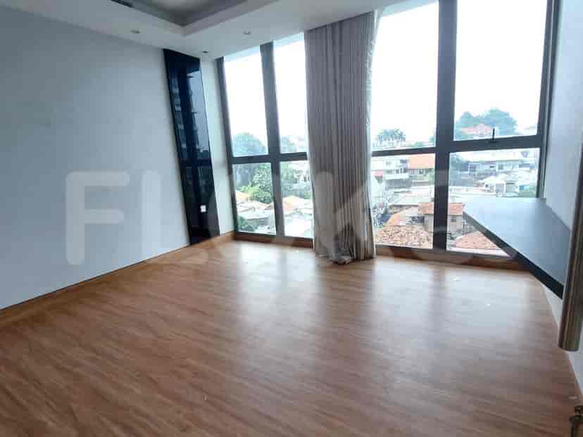 Bedroom with wood flooring and large windows with a view.