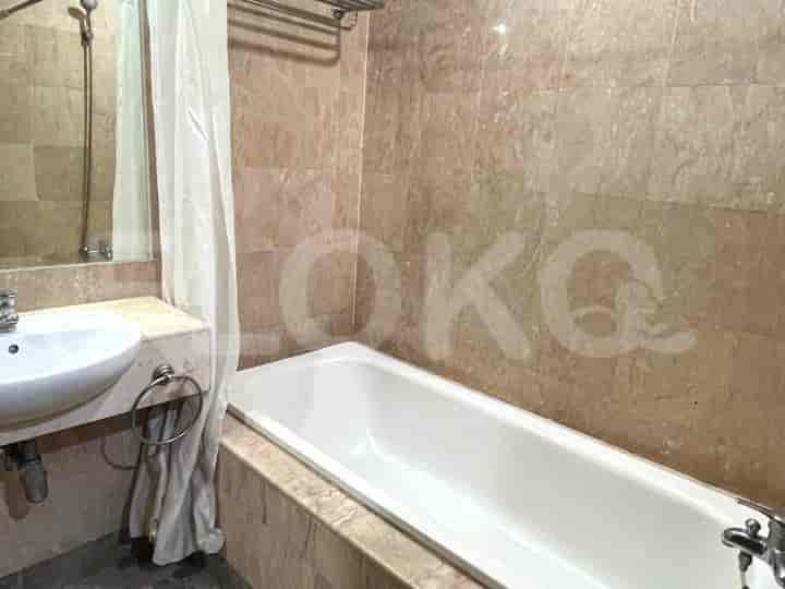 A bathroom with a bathtub and shower.