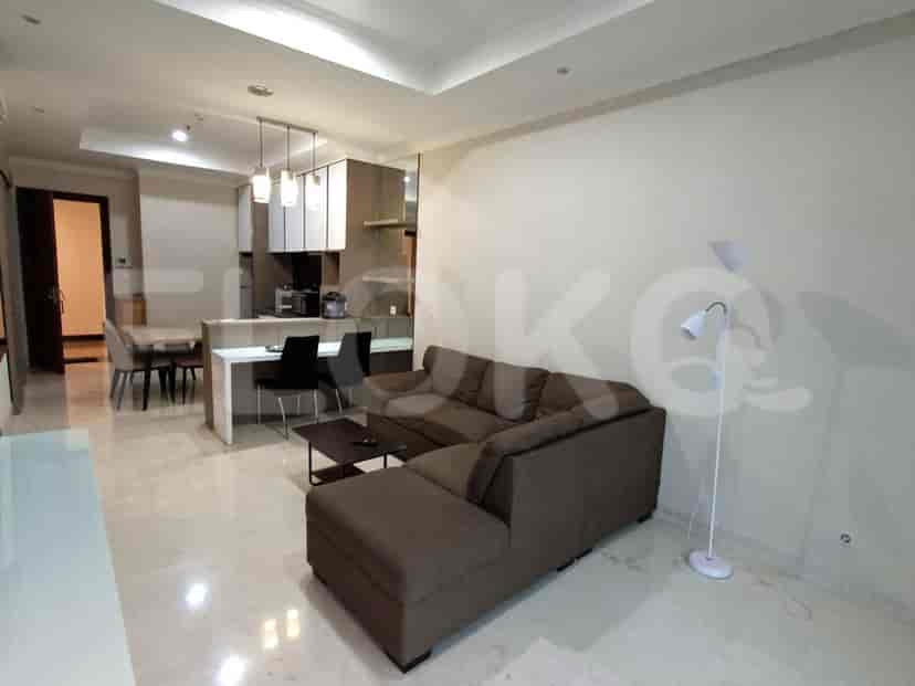 Modern apartment featuring an open-plan kitchen and living area with a grey sectional sofa.