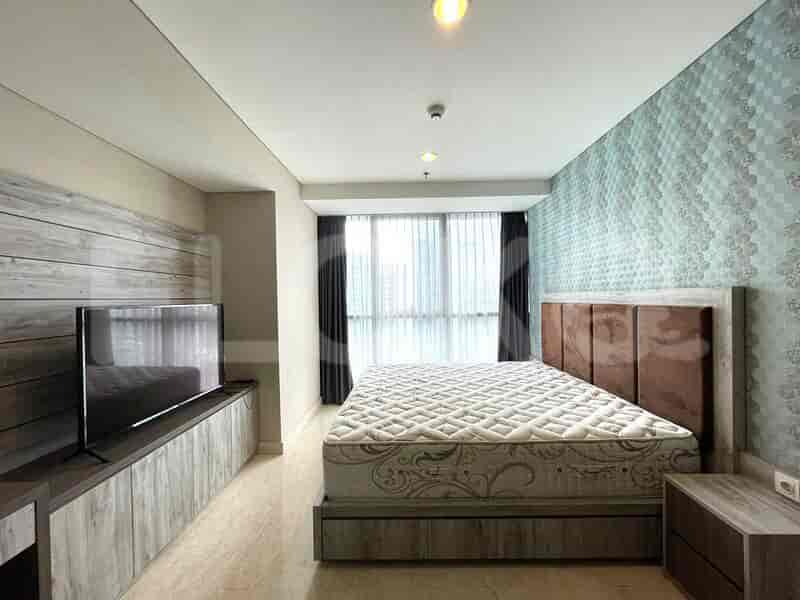 Modern bedroom with a queen-sized bed, wooden accents, and cityscape view.