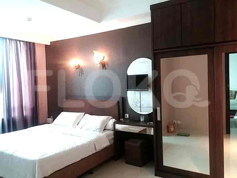 A bedroom featuring a bed, vanity, and closet.