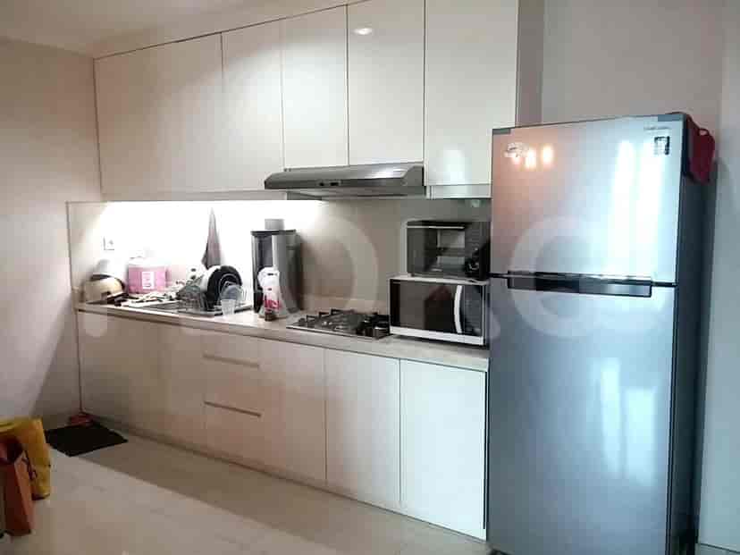 A modern kitchen with white cabinets, stainless steel appliances, and a small backsplash.