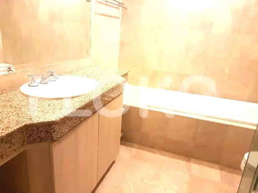 Bathroom with a bathtub and granite countertop.