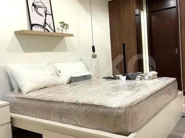 Bedroom featuring a bed, wardrobe, and minimalist decor.