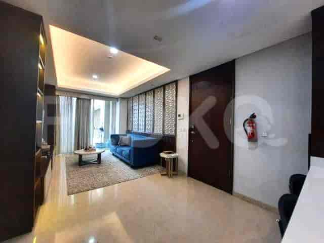 Another view of the living room showing the door and built-in storage.