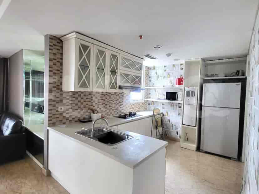 A well-lit kitchen with white cabinets, a gas stove, and a built-in microwave.