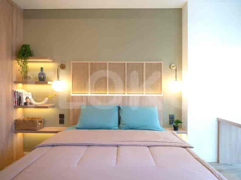 A modern bedroom with a light wooden bed frame, a headboard with a woven design, and accent lighting.