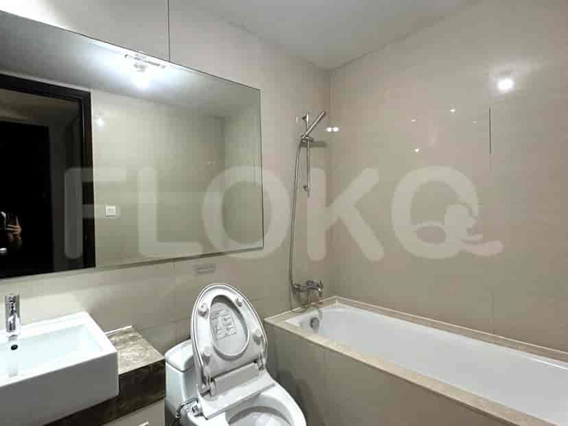 A spacious bathroom with a bathtub, large mirror, and modern fixtures.