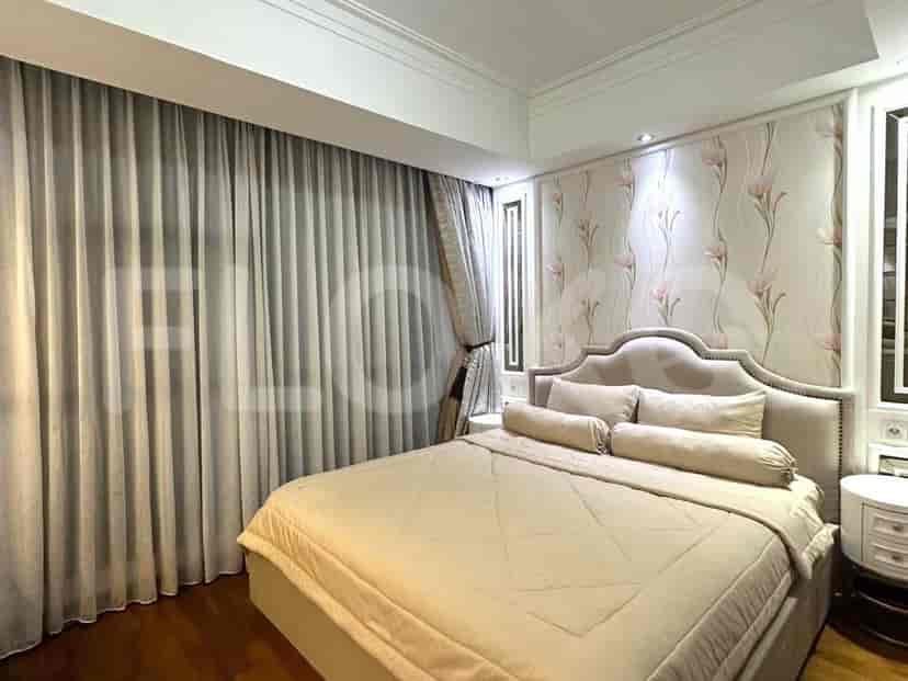 Elegant bedroom with a bed, curtains, and decorative floral wallpaper.