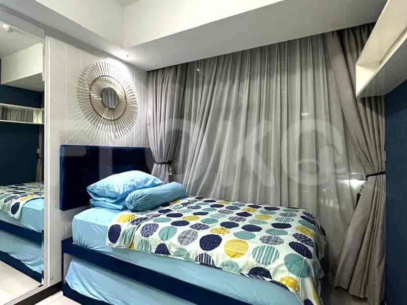 Modern bedroom with a bed, mirror, and patterned bedding.