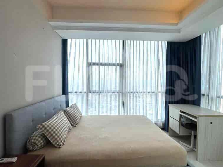 Bedroom with a large bed and floor-to-ceiling windows.