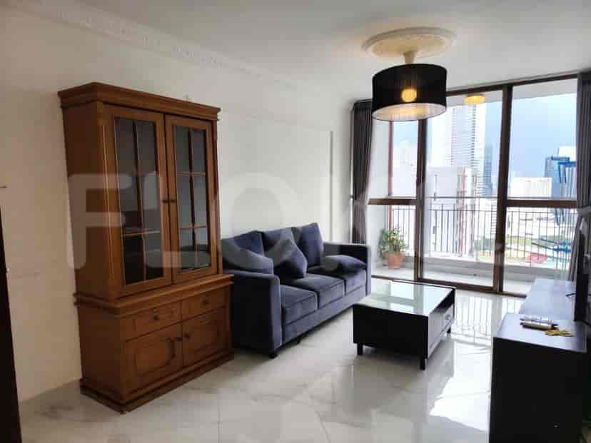Living room with a sofa, coffee table, and large cabinet.