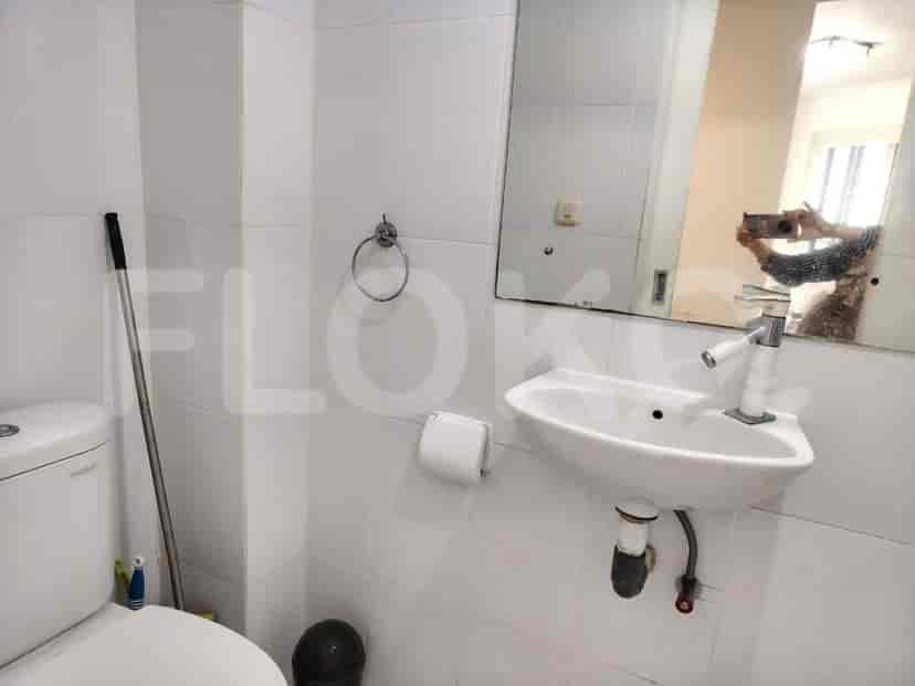 Clean bathroom with a sink, toilet, and a mirror.