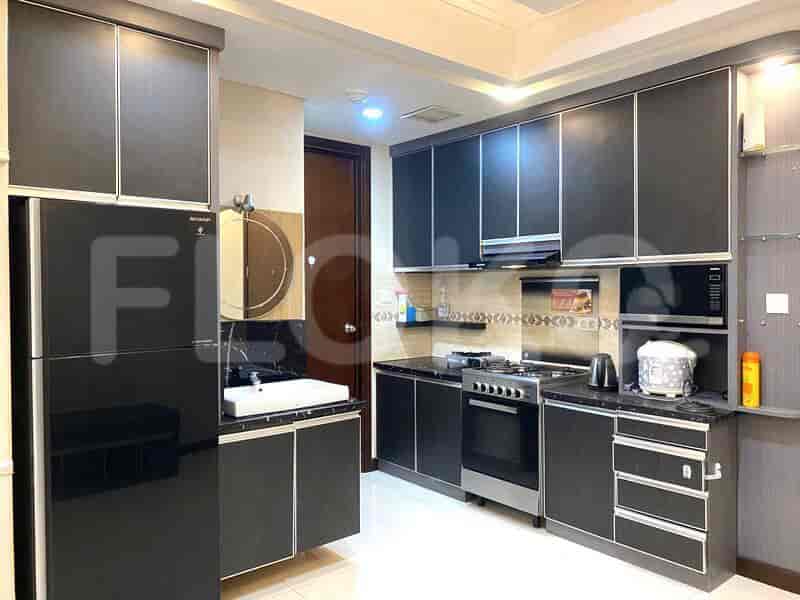 A modern kitchen with dark cabinets, stainless steel appliances, and a well-organized layout.