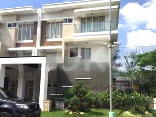 A modern two-story house with a carport, green lawn, and landscaped garden.
