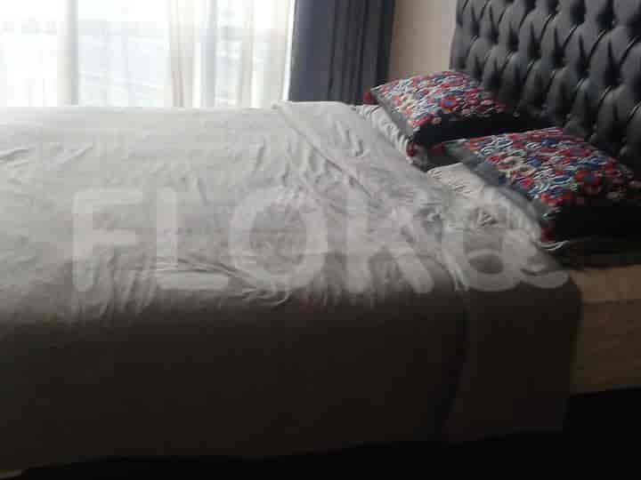 A bedroom with a large bed and dark headboard.