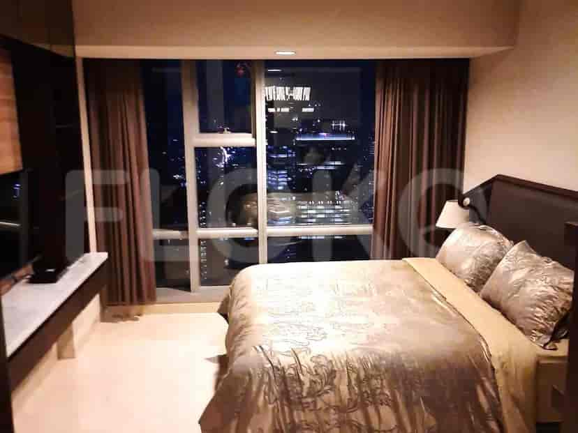 Bedroom with a bed, curtains, and city view.