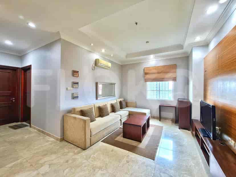 A living room with a sectional sofa, TV, and modern decor.