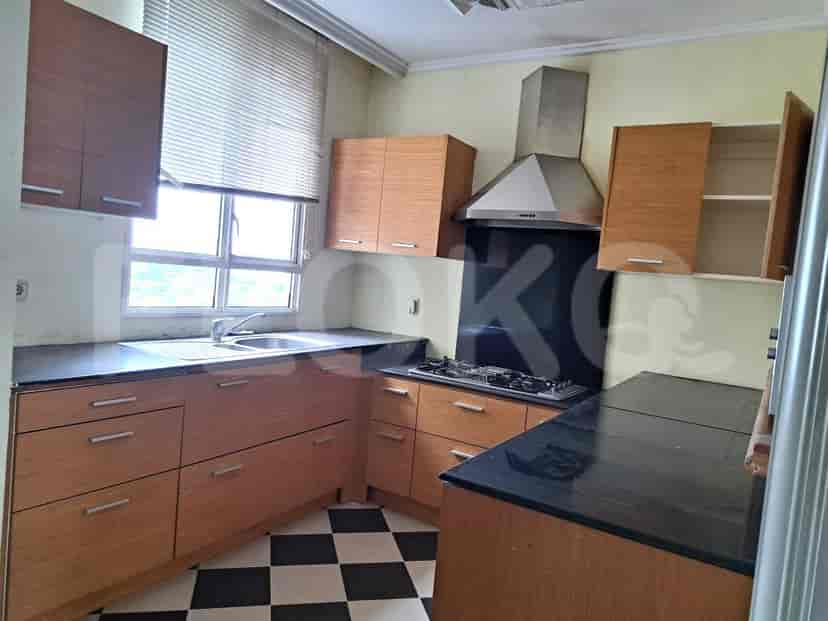 A kitchen with wooden cabinets and a black countertop.