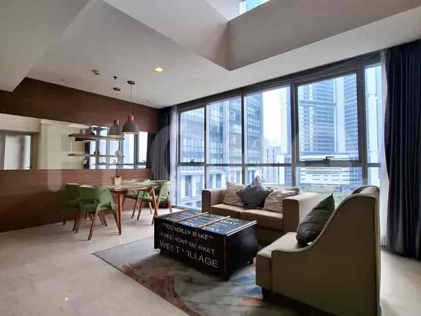 Modern living room with city views, a sofa, dining table, and coffee table.