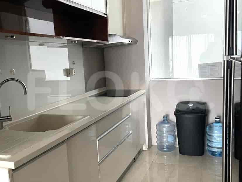 A modern kitchen with built-in appliances, a sink, and a neutral color scheme.