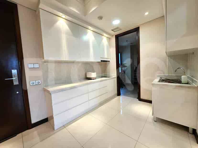 A modern kitchen with white cabinets and stainless steel appliances.