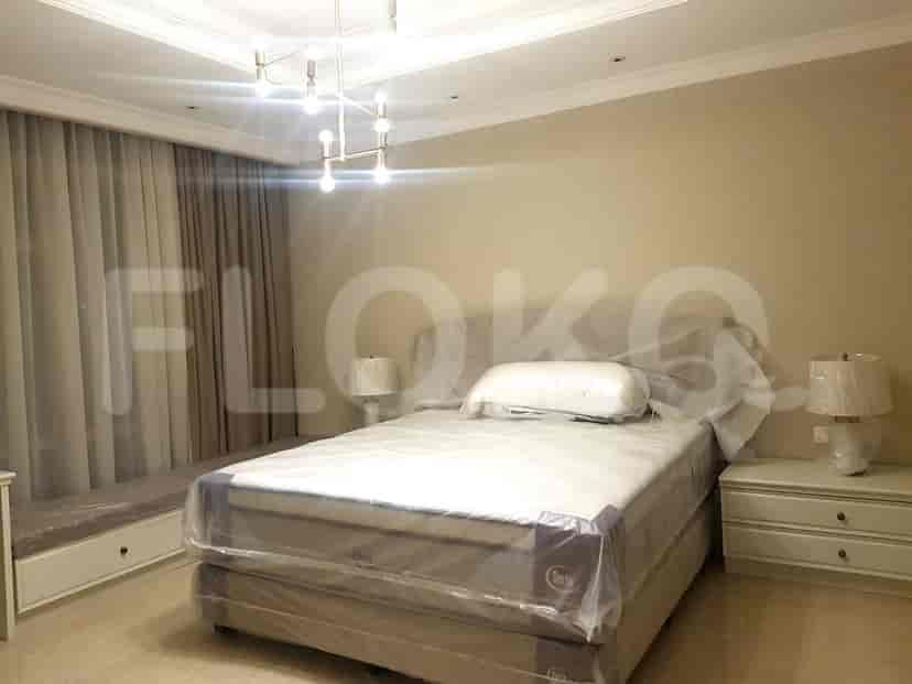 Bedroom with a bed, nightstands, and a modern chandelier.