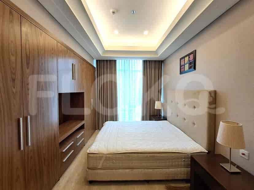 Elegant bedroom with a double bed and wooden wardrobe.