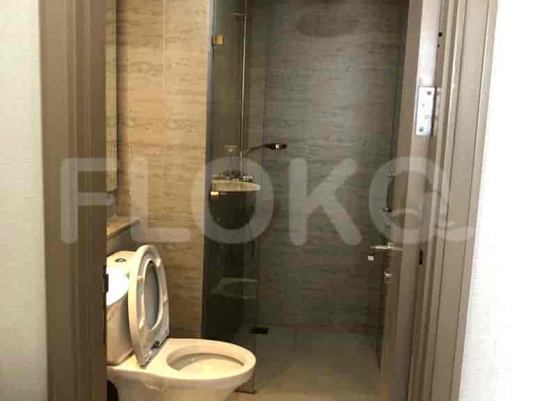 A modern bathroom featuring a walk-in shower and a toilet.