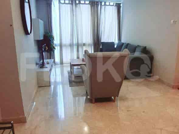 Living room with sofa, TV, and curtains.