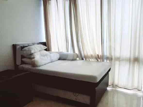 Bedroom with a bed and curtains.
