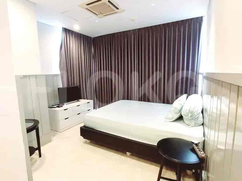 Cozy bedroom with a double bed, a TV, and sheer curtains.