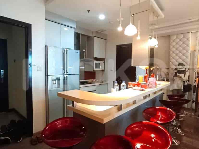 Modern kitchen with a breakfast bar, stainless steel appliances, and overhead lighting.