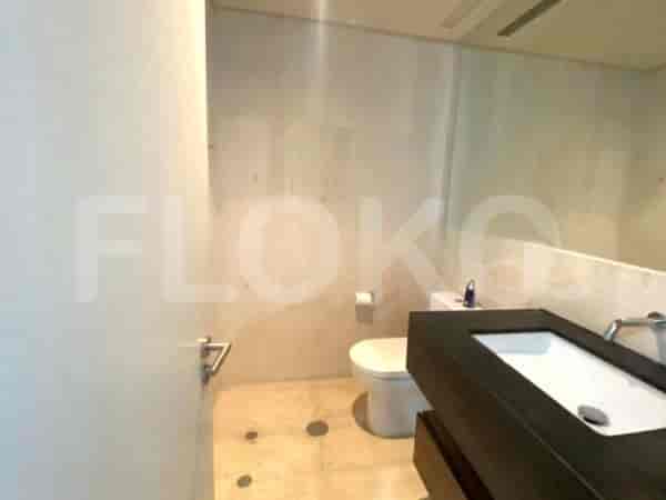 Modern bathroom with a sink, toilet, and neutral color scheme.
