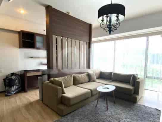 Living room with a brown L-shaped sofa, chandelier, and a large window.